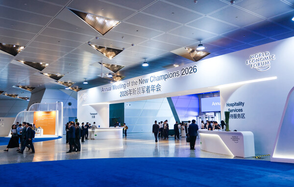 Visitors walking through a blue-lit exhibition hall